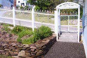 Custom-built arbor and fence at a custom landscape design. fences, gates, and arbors